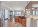 Kitchen with stainless steel appliances, wood cabinetry, eat-in island, and granite countertops at 255 Nicklaus Cir, Social Circle, GA 30025