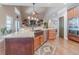 Kitchen with eat-in island, stainless steel appliances, wood cabinets, and granite countertops at 255 Nicklaus Cir, Social Circle, GA 30025