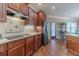 Updated kitchen showcasing wood cabinetry, stainless steel appliances, granite countertops, and tile backsplash at 255 Nicklaus Cir, Social Circle, GA 30025