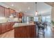 Well-lit kitchen featuring wood cabinets, granite countertops, stainless steel appliances, and eat-in island at 255 Nicklaus Cir, Social Circle, GA 30025