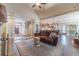 Open-concept living space with hardwood floors, a comfortable sofa, and kitchen view at 255 Nicklaus Cir, Social Circle, GA 30025