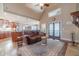 Spacious living room with hardwood floors, a fireplace, and an open layout connecting the kitchen at 255 Nicklaus Cir, Social Circle, GA 30025