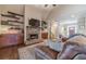 Cozy living room with a stone fireplace, built-in shelving, and comfortable seating at 255 Nicklaus Cir, Social Circle, GA 30025