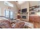 Spacious living room featuring stone fireplace, built-in shelving, and hardwood floors at 255 Nicklaus Cir, Social Circle, GA 30025