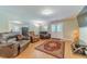 Spacious living area with luxury seating, wood-look flooring, and plenty of natural light at 255 Nicklaus Cir, Social Circle, GA 30025