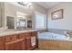 The main bath features a separate shower and soaking tub, with beautiful cherry cabinets at 255 Nicklaus Cir, Social Circle, GA 30025