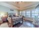 Spacious main bedroom with trey ceilings, hardwood floors, and a bright window overlooking the yard at 255 Nicklaus Cir, Social Circle, GA 30025