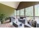 Relaxing screened-in patio featuring comfortable seating and wooded views with a beautiful wooded backdrop at 255 Nicklaus Cir, Social Circle, GA 30025