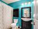 Stylish bathroom featuring a vanity with storage, a toilet, and a shower, all in a vibrant color scheme at 3740 Arminto Dr, Ellenwood, GA 30294