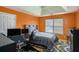 This bedroom has orange walls with a patterned carpet at 3740 Arminto Dr, Ellenwood, GA 30294