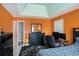 The orange bedroom features a tray ceiling and a spacious feel at 3740 Arminto Dr, Ellenwood, GA 30294