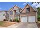 Traditional brick home boasts a two-car garage, well-maintained landscaping, and inviting curb appeal at 3740 Arminto Dr, Ellenwood, GA 30294