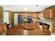 Functional kitchen with modern appliances, wood cabinets, and a dining area for convenient Gathering meals at 3740 Arminto Dr, Ellenwood, GA 30294