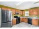 Efficient kitchen features stainless steel appliances, wood cabinets, and laminate countertops for easy meal preparation at 3740 Arminto Dr, Ellenwood, GA 30294