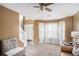 Cozy living room with large windows, neutral carpet, and comfortable seating arrangement provides ample natural light at 3740 Arminto Dr, Ellenwood, GA 30294