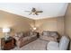 Comfortable living room with sofas, accent chair, ceiling fan, and neutral carpet perfect for relaxing and entertaining at 3740 Arminto Dr, Ellenwood, GA 30294