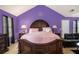 Vaulted primary bedroom featuring a comfortable bed and dark furniture, creating a cozy and stylish personal space at 3740 Arminto Dr, Ellenwood, GA 30294