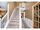 Inviting foyer with a carpeted staircase and white railing leads to the upper level of the home at 3740 Arminto Dr, Ellenwood, GA 30294
