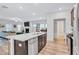 Open-concept kitchen with stainless steel appliances, a kitchen island, and an open view into the living room at 4658 Electric Sw Ave, Mableton, GA 30126