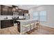 Modern kitchen with stainless steel appliances, granite countertops, and an island with barstool seating at 4658 Electric Sw Ave, Mableton, GA 30126