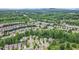 Expansive aerial view of a neighborhood with trees, homes, and roads at 6155 Falls Landing Dr, Cumming, GA 30040