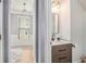 Modern bathroom featuring sleek vanity, stylish mirror, and hardwood floors at 6155 Falls Landing Dr, Cumming, GA 30040