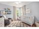 This Bedroom has a neutral color palette, large window, and a full-sized crib at 6155 Falls Landing Dr, Cumming, GA 30040