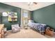 This bedroom has an accent wall, large window, and ceiling fan at 6155 Falls Landing Dr, Cumming, GA 30040