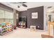 This bonus room has neutral paint, a large window, and plenty of space for activities at 6155 Falls Landing Dr, Cumming, GA 30040