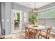 Cozy breakfast nook with wood table, views to the patio, and natural lighting at 6155 Falls Landing Dr, Cumming, GA 30040
