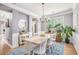 Elegant dining room with stylish chandelier, plenty of space, and hardwood floors at 6155 Falls Landing Dr, Cumming, GA 30040