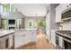 Open kitchen design with an island, modern appliances, and ample natural light at 6155 Falls Landing Dr, Cumming, GA 30040