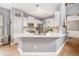 Modern kitchen featuring stainless steel appliances, breakfast bar, and light countertops at 6155 Falls Landing Dr, Cumming, GA 30040
