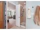 This ensuite bathroom boasts a step-in shower with glass doors and built-in shelving at 6155 Falls Landing Dr, Cumming, GA 30040