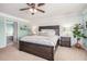 This spacious main bedroom features a decorative ceiling fan, wood accent wall, and ensuite bathroom at 6155 Falls Landing Dr, Cumming, GA 30040