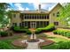 Scenic backyard showcases a screened porch, manicured hedges, and a charming garden at 1187 Ward Creek Sw Dr, Marietta, GA 30064