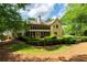 Well-manicured backyard with a screened porch, manicured hedges, and lush greenery at 1187 Ward Creek Sw Dr, Marietta, GA 30064