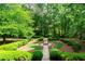 Secluded backyard features mature trees, manicured hedges, and a serene garden space at 1187 Ward Creek Sw Dr, Marietta, GA 30064
