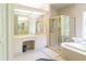 Bright bathroom with a bathtub, separate shower, vanity, and tiled walls at 1187 Ward Creek Sw Dr, Marietta, GA 30064