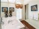 Well-lit bathroom with a large mirror, decorative art, and a sink with elegant lamps at 1187 Ward Creek Sw Dr, Marietta, GA 30064