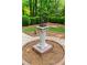 Beautifully landscaped garden featuring an ornamental sundial and manicured hedges at 1187 Ward Creek Sw Dr, Marietta, GA 30064