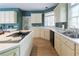 Bright kitchen featuring cream cabinetry, hardwood floors, stainless steel appliances and natural light at 1187 Ward Creek Sw Dr, Marietta, GA 30064