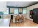 Bright eat-in kitchen featuring white cabinets, modern appliances, and hardwood floors at 1187 Ward Creek Sw Dr, Marietta, GA 30064