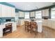 Spacious kitchen with cream cabinets, central island, hardwood floors and a desk area at 1187 Ward Creek Sw Dr, Marietta, GA 30064