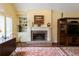 Cozy living room featuring a brick fireplace, built-in shelving, and shuttered windows at 1187 Ward Creek Sw Dr, Marietta, GA 30064