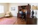 Cozy home office featuring a dark wood desk, chair, and decorative elements at 1187 Ward Creek Sw Dr, Marietta, GA 30064