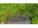 Aerial view of home with dark shingled roof surrounded by lush green trees at 161 Gann Cemetery Rd, Dallas, GA 30157