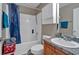 Full bathroom with a shower-tub combo, white vanity, and a blue shower curtain at 161 Gann Cemetery Rd, Dallas, GA 30157