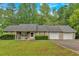 Ranch-style home featuring a front porch and an attached two-car garage, set on a lush green lot at 161 Gann Cemetery Rd, Dallas, GA 30157