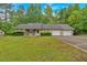 Well-maintained single-story home with a lush green lawn, double garage, and inviting front porch at 161 Gann Cemetery Rd, Dallas, GA 30157